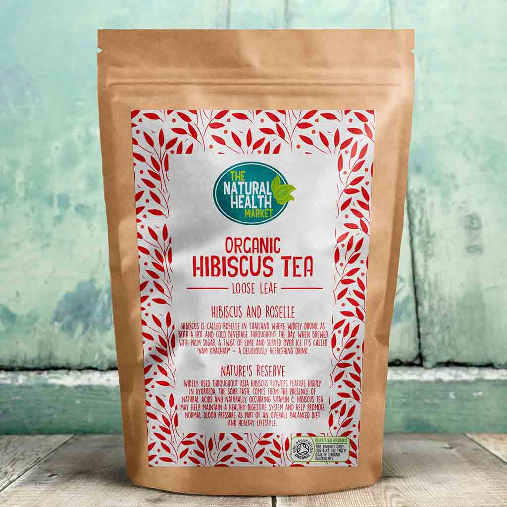 Bag of Organic Hibiscus Tea loose leaf with a decorative label on a wooden surface.