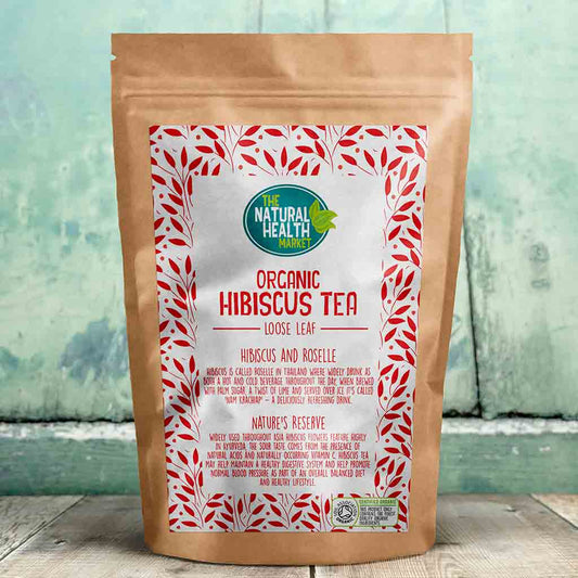 Bag of Organic Hibiscus Tea loose leaf with a decorative label on a wooden surface.