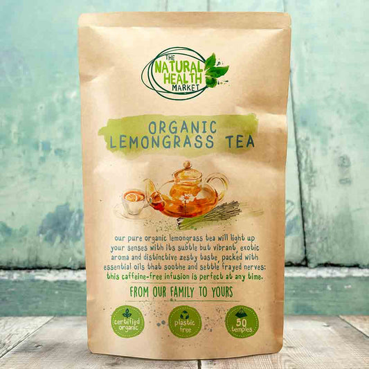 Kraft paper packaging of Organic Lemongrass Tea from The Natural Health Market on a wooden surface with a blurred natural background.