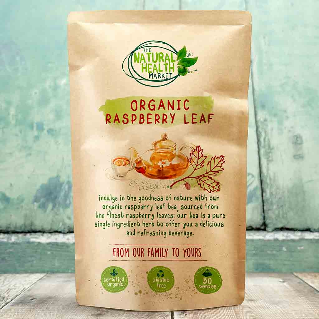 Package of Organic Raspberry Leaf tea from The Natural Health Market on a wooden surface with a blurred natural background.