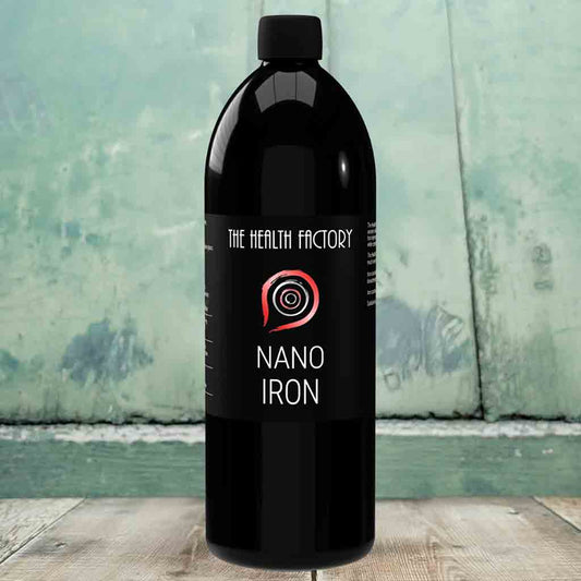 A bottle of nano iron liquid on a wooden floor.