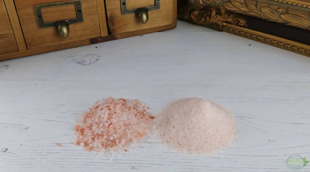 Two heaps of Himalayan pink rock salt side by side – coarse and fine grain, showcasing natural mineral-rich salt variations.