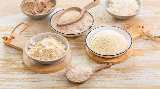 Five Bowls of organic psyllium husk powder each a different grade of powder from fine to corse.