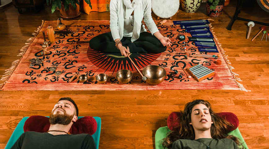 Tibetan singing bowls help a man and woman get some Non-Sleep Deep Rest (NSDR)