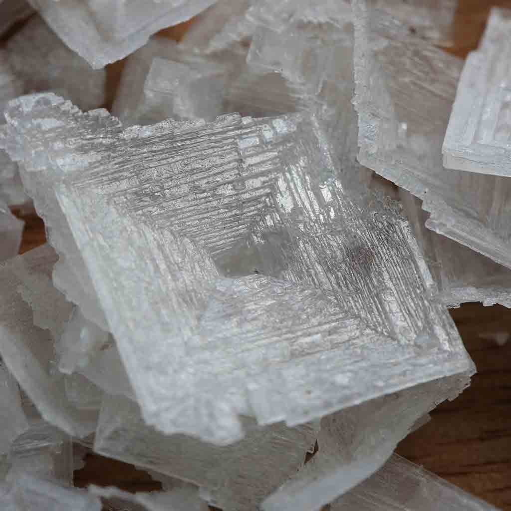 Close-up of translucent Blackthorn Salt crystal blocks with a rough texture.