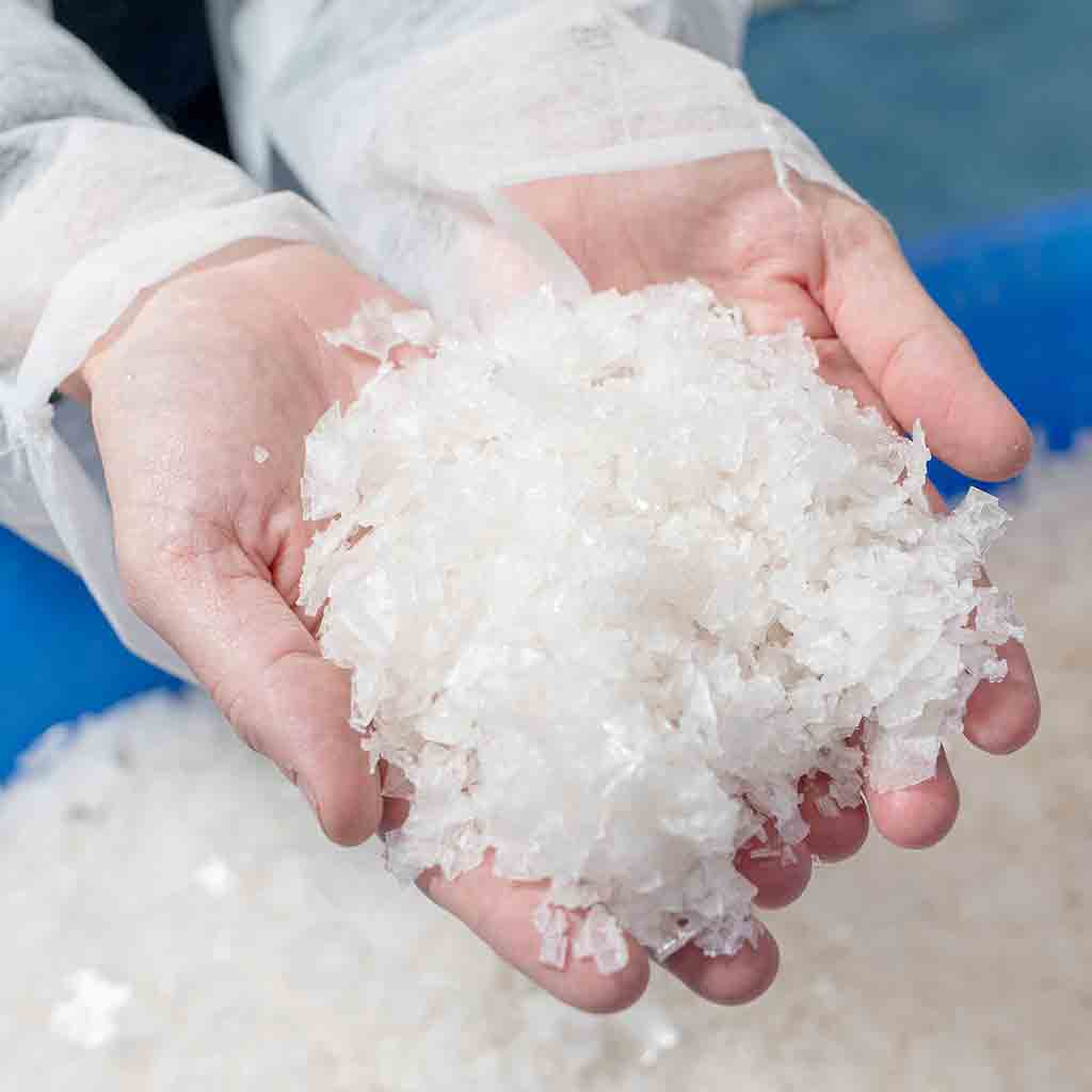 Hands holding a pile of Blackthorn Sea Salt crystals.