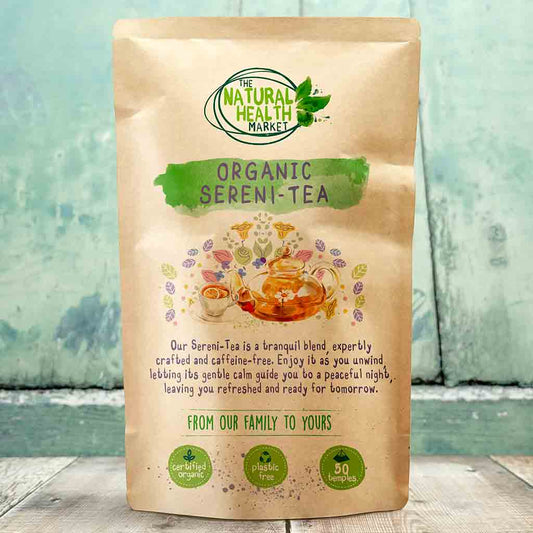 Tea package from The Natural Health Market with branding and product description on a wooden surface.