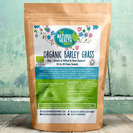 Package of Organic Barley Grass from The Natural Health Market on a wooden surface with a green background.