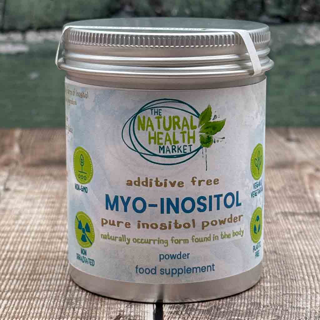 Container of MYO-INOSITOL powder from The Natural Health Market on a wooden surface.