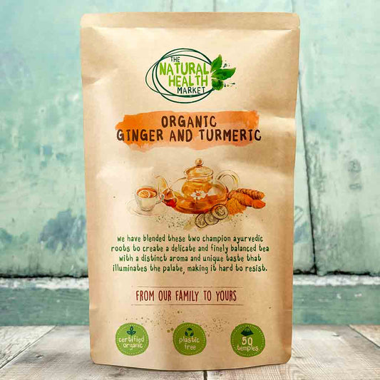 Bag of organic ginger and turmeric from The Natural Health Market on a wooden surface with a blue-green gradient background.