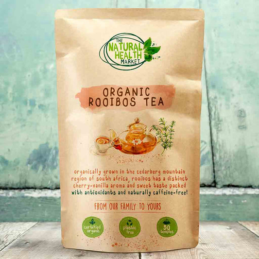 Bag of Organic Rooibos Tea from The Natural Health Market on a wooden surface with a blue-green gradient background.
