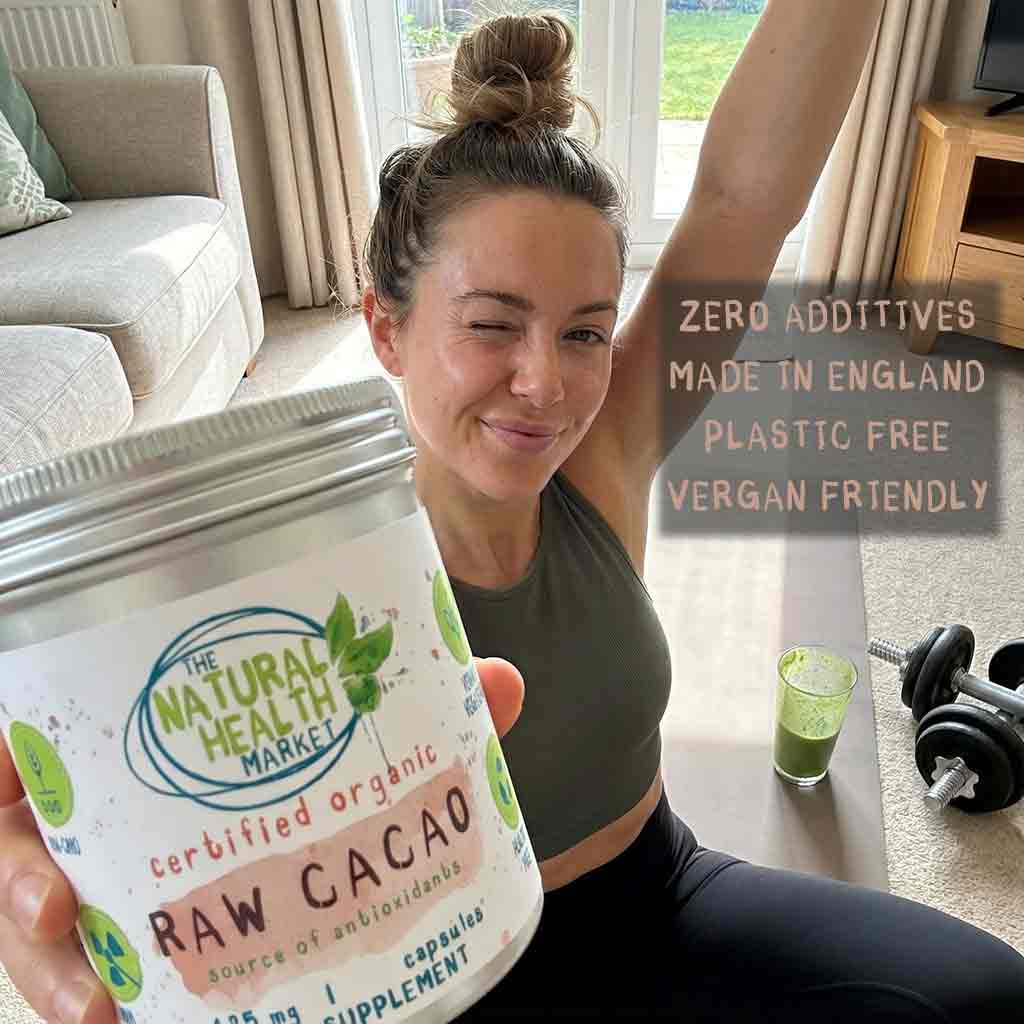 Woman holding a container of 'Raw Cacao' from The Natural Health Market in a home setting.