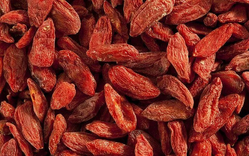 A zoomed in image of bright red fresh goji berries.