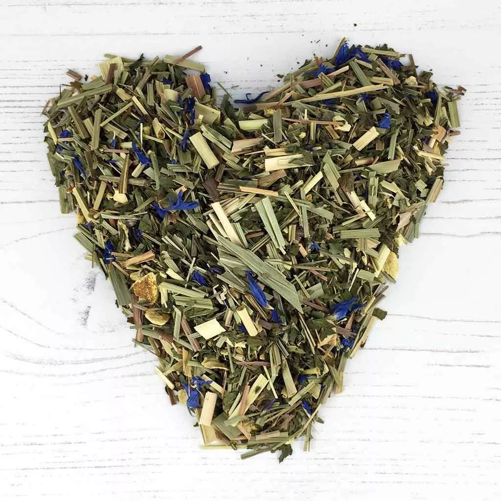 A heap of lemongrass and ginger made into a heart shape on a white background.
