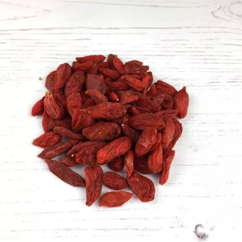 A heap of goji berries on a white background.