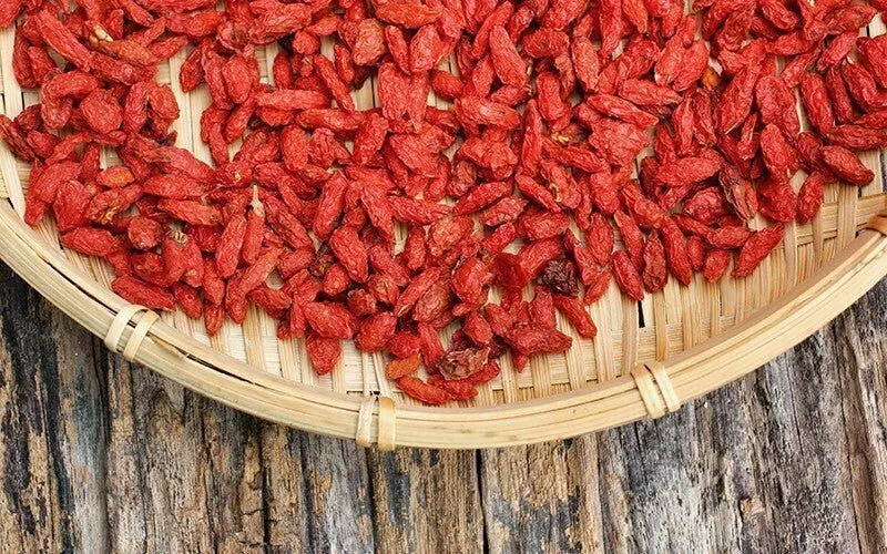 A wicker bowl filled with goji berries.