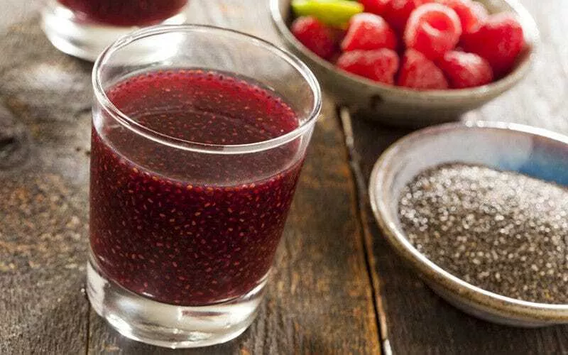 Chia seeds mixed with cranberry juice and a bowl of chia on the side.