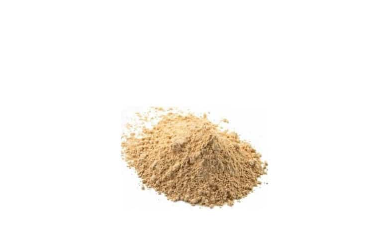 A heap of maca root powder on a white background.