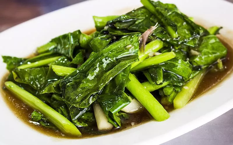 A dish of leafy green vegetables.
