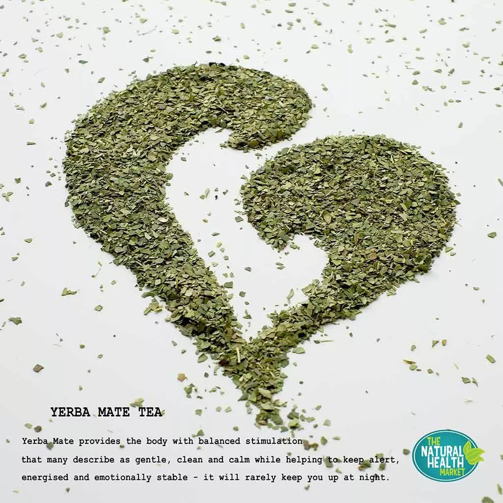 Loose yerba mate leaves on white background shaped into a heart.