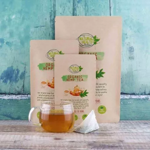 Organic Hemp Tea Bags by The Natural Health Market - All sizes with a freshly brewed cup of hemp tea in a glass cup.